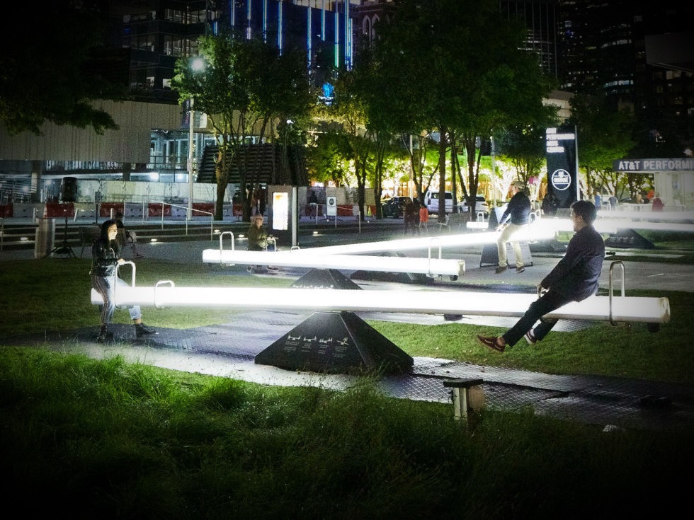 An illuminated seesaw installation.